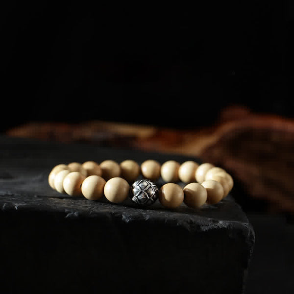 Peach Wood Cinnabar Bracelet – Geometric carved metal bead on light wood beads on slate, artisan spiritual