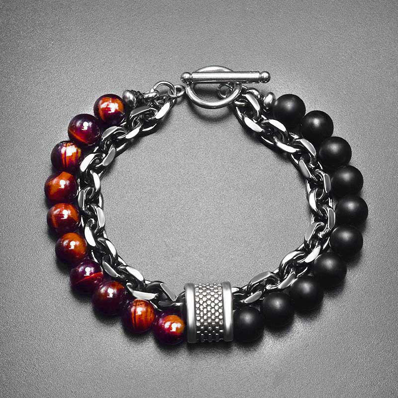 Tiger Eye Lazurite Malachite Protection Bracelet – Top-down view of men's bracelet with red tiger's eye and black onyx beads, silver chain, dimpled metal spacer, and toggle closure on gray surface
