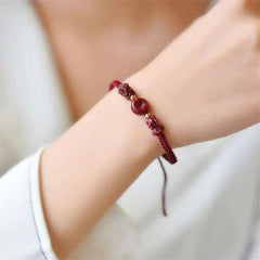 Cinnabar PiXiu Copper Coin Red String Bracelet – Red bracelet worn on wrist with white sleeve, lifestyle gift