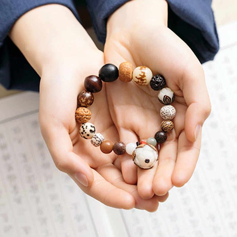 Bodhi Seed Lotus Mala – Cupped hands displaying varied bodhi seed beads and focal charm, peace