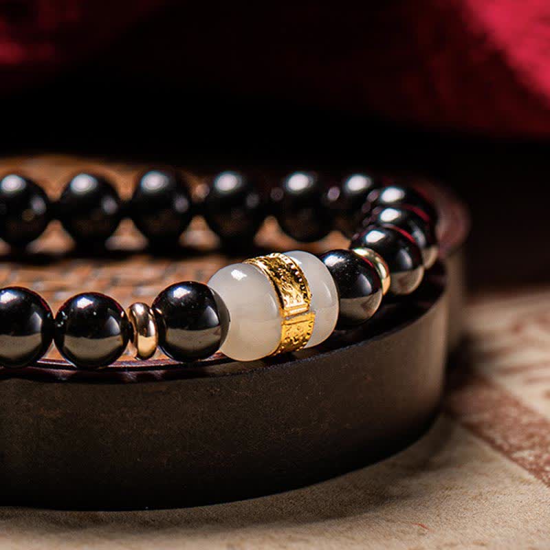 Black Obsidian Jade Bracelet – Dramatic low-angle on dark stand emphasizing jade and gold contrast, obsidian jewelry