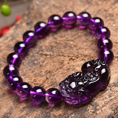 Amethyst PiXiu Fortune Bracelet – Purple amethyst bracelet on wood surface, carved PiXiu detail, good luck