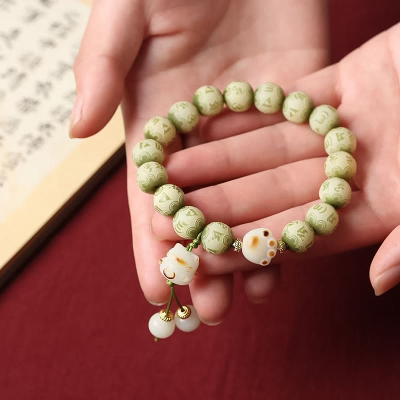 Bodhi Seed Bracelet – Close-up of green beads and cat paw charm resting on hand, spiritual bracelet