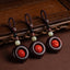 Tibetan Om Mani Padme Hum Sandalwood Cinnabar Protection Keychain – three variants displayed on wood, protection keychain