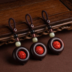 Tibetan Om Mani Padme Hum Sandalwood Cinnabar Protection Keychain – three variants displayed on wood, protection keychain