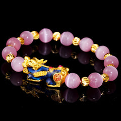 Pixiu Cat Eye Chrysoberyl Lucky Bracelet – lifestyle worn on wrist showing pink beads, lucky charm bracelet