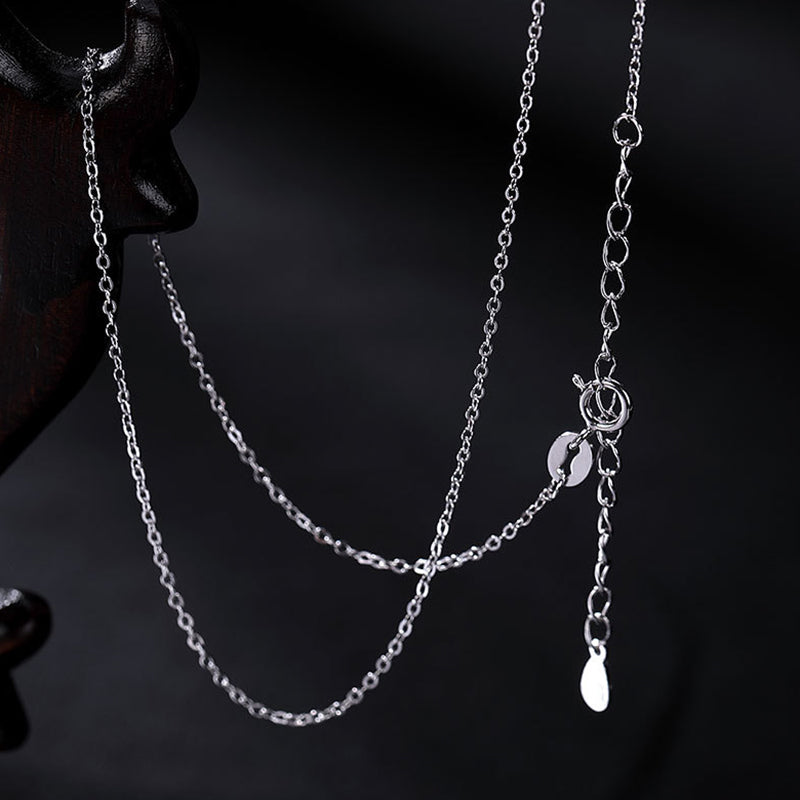 Zen Cairn Crystal Pendant – silver chain necklace on dark mannequin bust, polished clasp detail