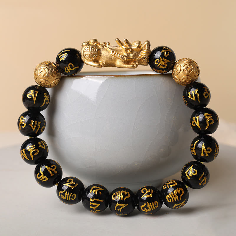 FengShui PiXiu Obsidian Bracelet – draped around white ceramic cup beige background, obsidian wealth jewelry