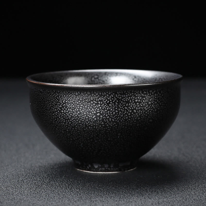 Gold Leaf Jianzhan Teacup – Hand holding jianzhan bowl with gold koi motif, kung fu tea set