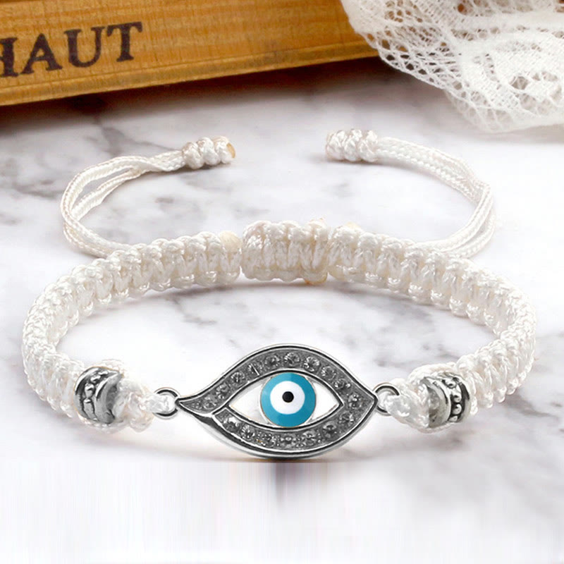 White cord evil eye bracelet with silver turquoise evil eye crystal charm, marble photo