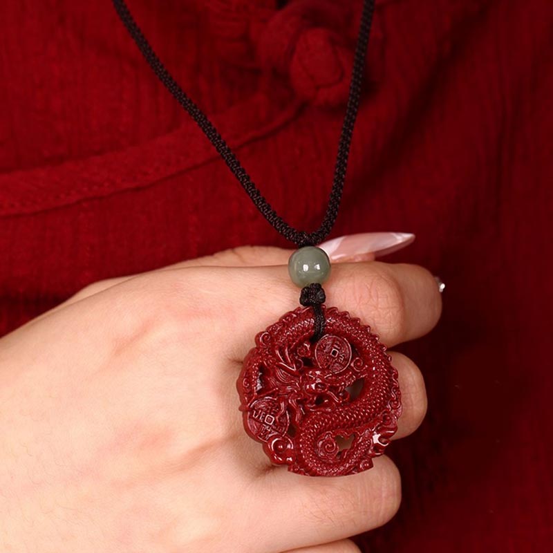 Cinnabar Hetian Jade Dragon Necklace - coiled dragon pendant in cupped hand, red silk setting