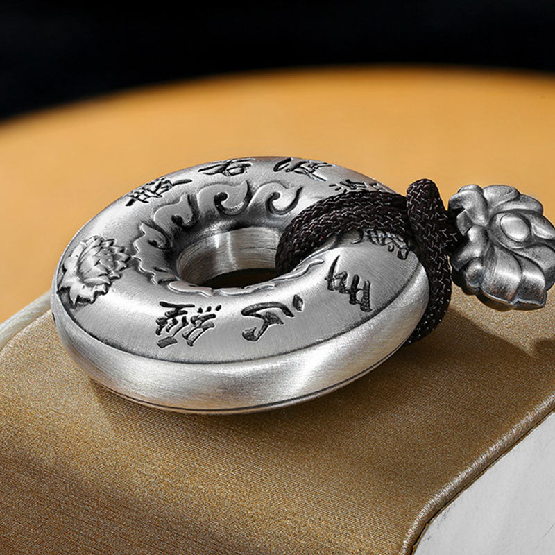 Silver Heart Sutra Pendant – silver bi-disc with calligraphy and lotus on black cord, golden fabric, antique