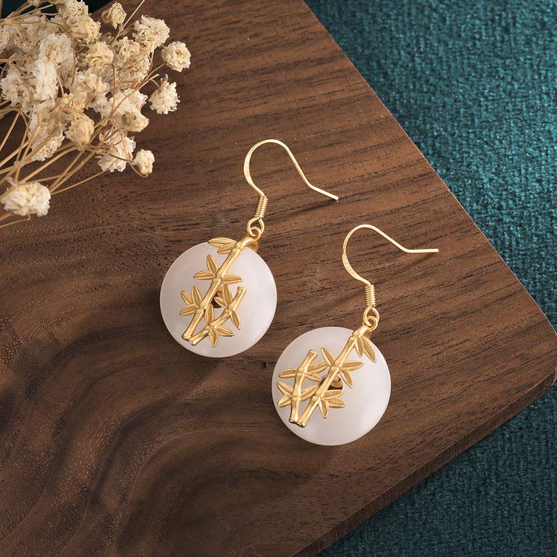 FengShui White Jade Fortune Earrings detail shot on dark background