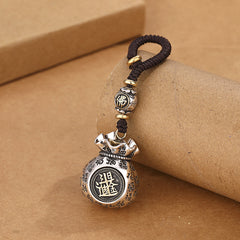Rotating coin money pouch keychain with Fu characters and wealth symbols on pure white background