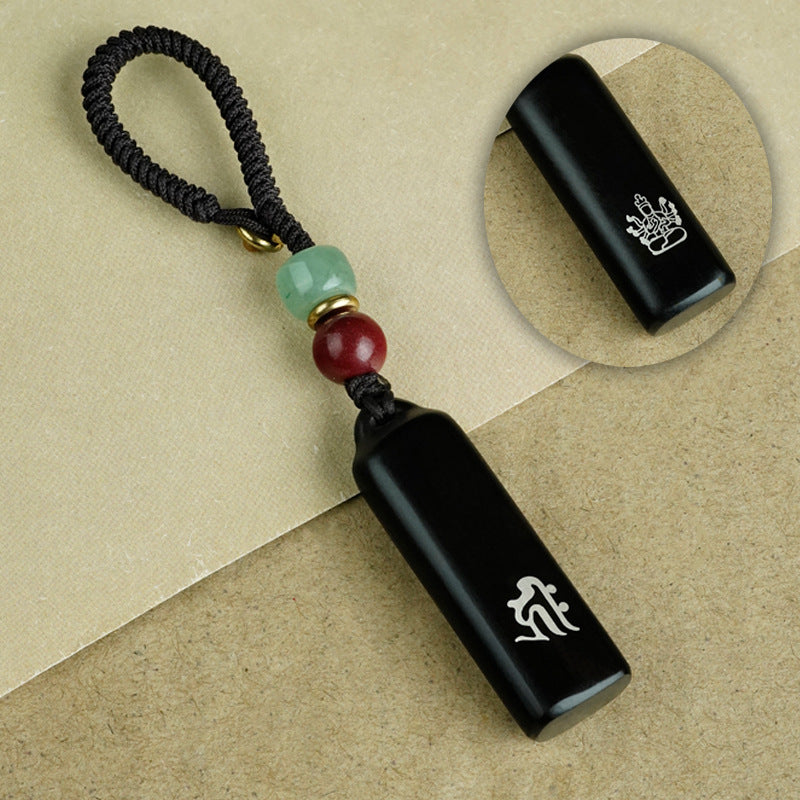 Ebony Eight Guardians talisman keychain with silver inlay for Goat and Monkey zodiac Buddhist protection