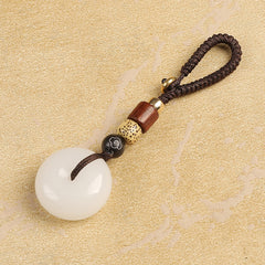 Natural white agate ping an kou peace buckle keychain on beige textured background