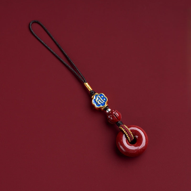 Natural cinnabar zodiac amulet with blue enamel zodiac charm detailed close-up