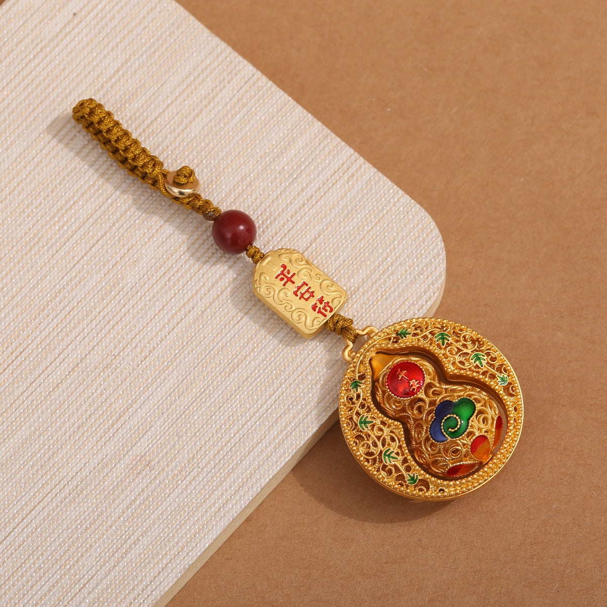 Gold filigree calabash keychain with peace talisman, red agate bead and golden cord