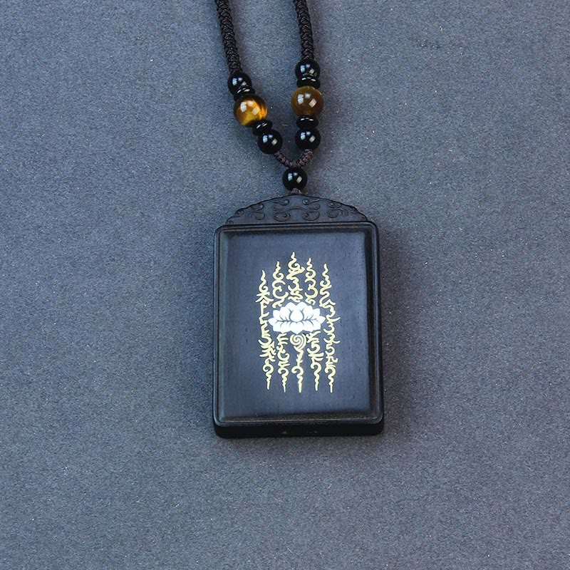 Ebony Wood Lotus Pendant – Overhead flat lay with sacred flame design, Meditative