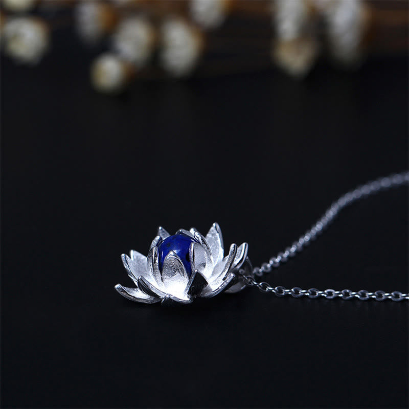 Lapis Lazuli Lotus Necklace - centered silver lotus bloom with blue cabochon on black, lotus jewelry