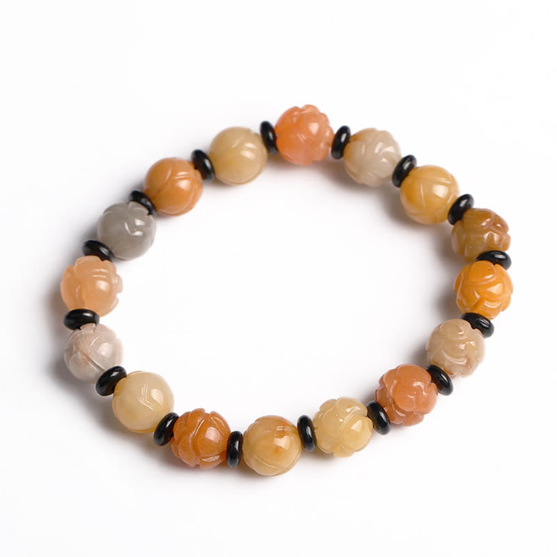 Golden Silk Jade Lotus Bracelet – Warm amber lotus carved beads with black spacers on white, golden silk jade