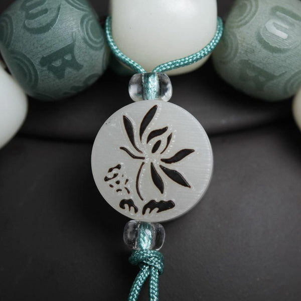 White Bodhi Seed Om Mani Padme Hum Bracelet – Lotus pendant close-up with crystal accents, bodhi jewelry