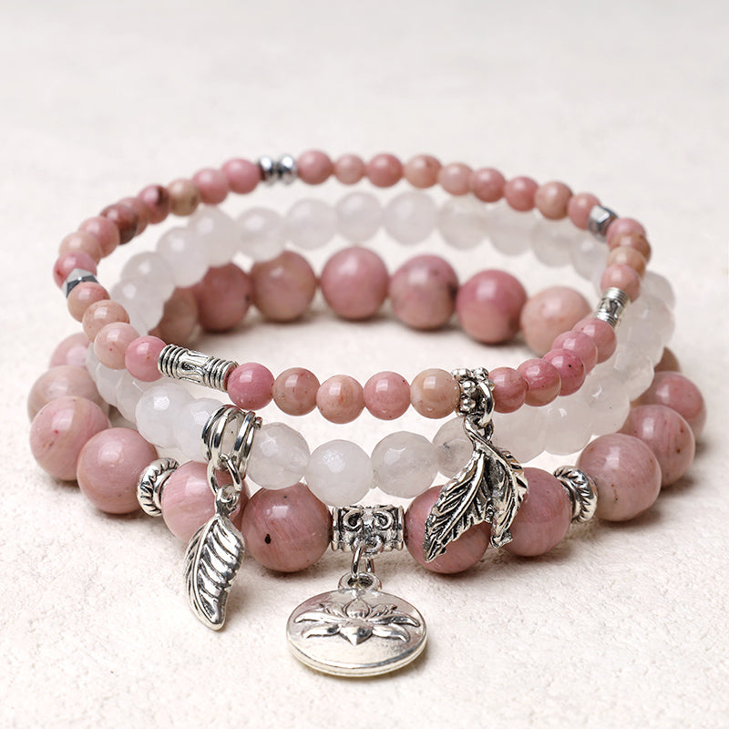 Crystal Lotus Bracelet – pink rhodochrosite and white quartz three-piece stack with silver feather charms, crystal jewelry