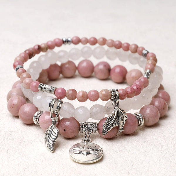 Crystal Lotus Bracelet – pink rhodochrosite and white quartz three-piece stack with silver feather charms, crystal jewelry
