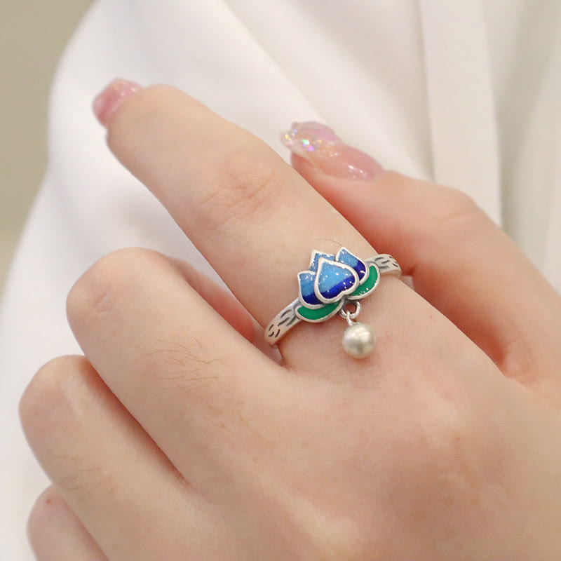 Lotus Flower Copper Ring - silver lotus with blue enamel worn on finger against white, peaceful