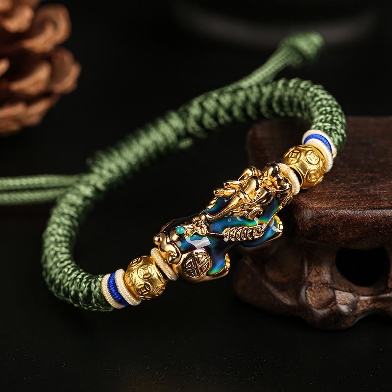 Feng Shui PiXiu Bracelet – green braided cord color change Pixiu gold beads, dark wood background