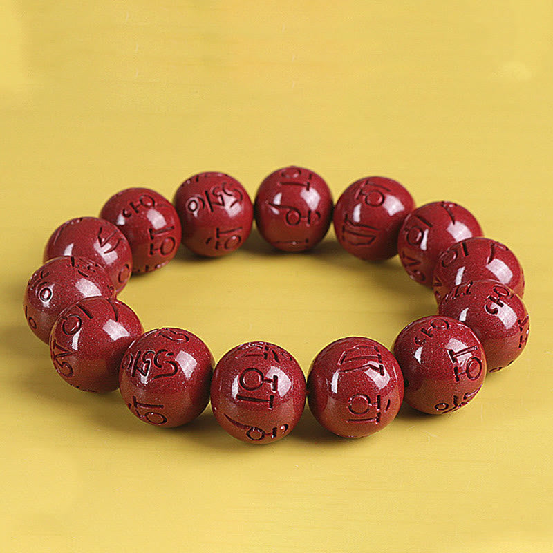 Double PiXiu Cinnabar Bracelet – Red carved bead bracelet front view on yellow, intention jewelry