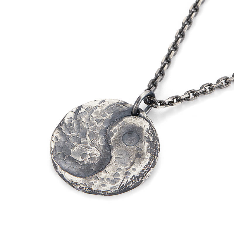 Sterling Silver Yin Yang Necklace – Angled close-up of hammered yin-yang pendant on cable chain, white bg