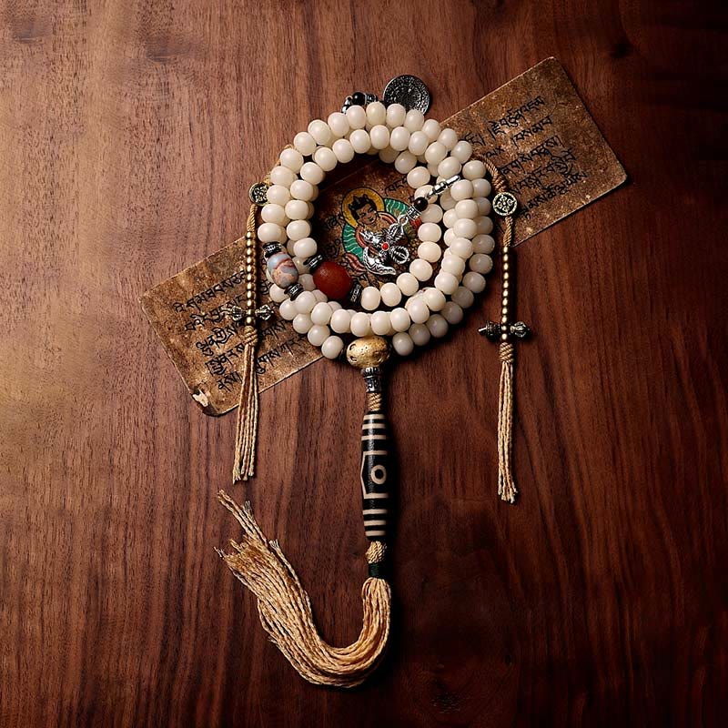 108 Mala Beads Bracelet – Mala with deity charm and dzi pendant on wood