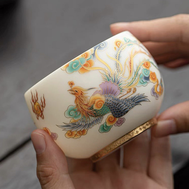 Dragon Phoenix Clouds Ceramic Teacup - Handheld phoenix cup showing colorful plumage and ruyi clouds, artisanal