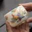 Dragon Phoenix Clouds Ceramic Teacup - Handheld phoenix cup showing colorful plumage and ruyi clouds, artisanal