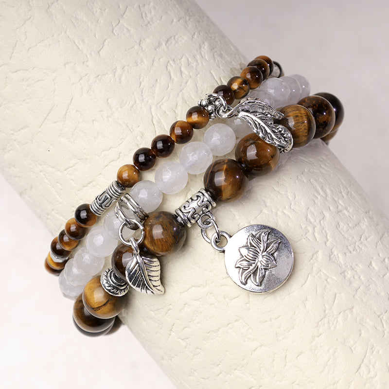 Natural Crystal Bracelet – tiger's eye and milky white quartz on display stand with silver lotus charm, stacking bracelet