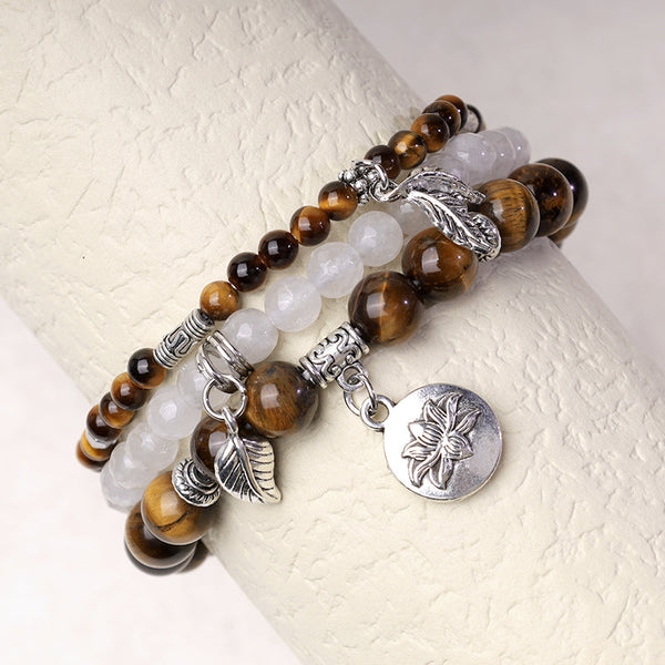 Natural Crystal Bracelet – tiger's eye and milky white quartz on display stand with silver lotus charm, stacking bracelet