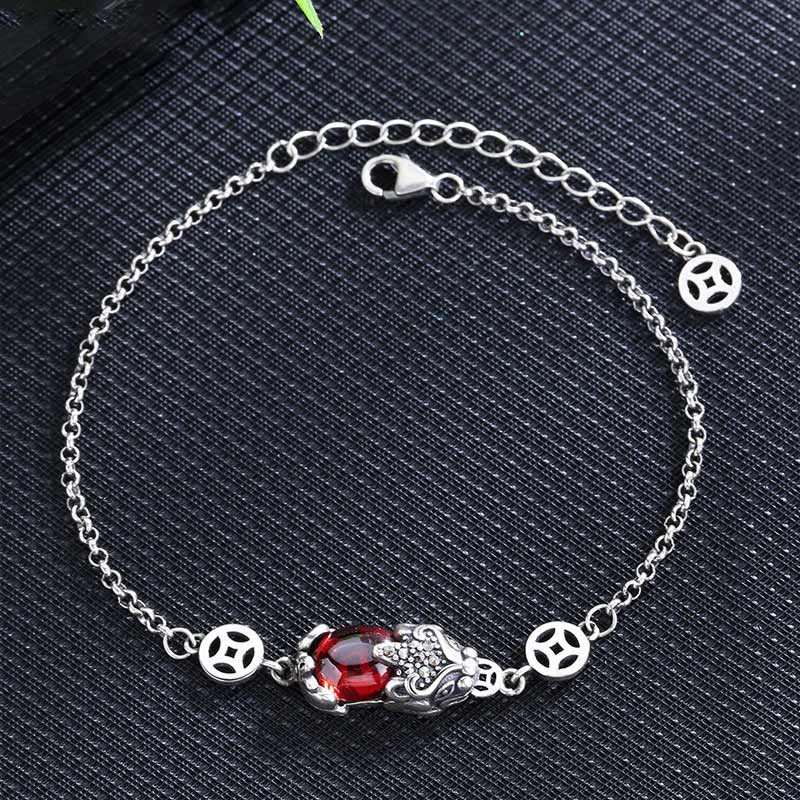 Copper Garnet PiXiu Wealth Bracelet – Silver chain with red garnet PiXiu on dark textured fabric background