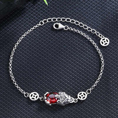 Copper Garnet PiXiu Wealth Bracelet – Silver chain with red garnet PiXiu on dark textured fabric background