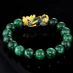 FengShui PiXiu Jade Bracelet – green jade beads gold enamel PiXiu on black reflective surface, FengShui
