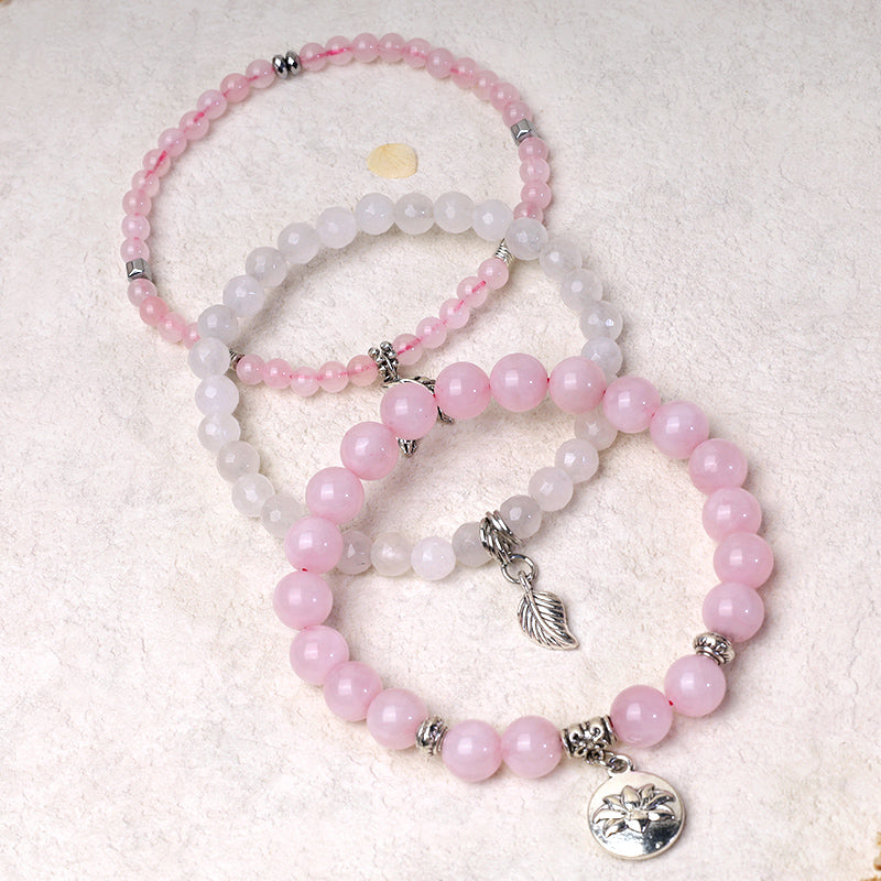 Lotus Bracelet Set – pastel pink and white stackable beads with silver feather charm and lotus medallion, gemstone bracelet