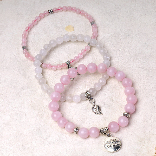 Lotus Bracelet Set – pastel pink and white stackable beads with silver feather charm and lotus medallion, gemstone bracelet