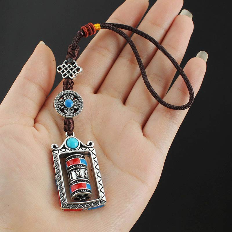 Om Mani Padme Hum Prayer Wheel Keychain – Held in palm showing scale, black background, Tibetan blessing keychain