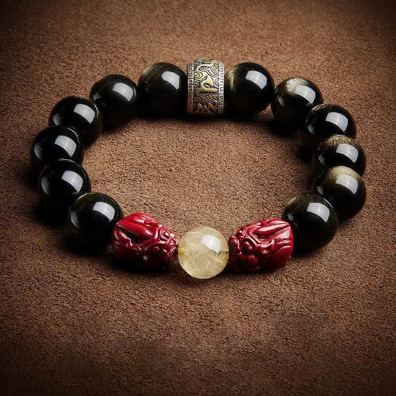 Gold Sheen Obsidian Pixiu Bracelet – top view golden sheen obsidian on brown fabric, om mani padme hum bronze spacer