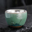 Butterfly Koi Cup – held in hand displaying 120ml size, ceramic kung fu tea