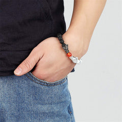 White Turquoise Lava Rock Dragon Bracelet – Worn on wrist showing dragon charm centerpiece on denim, Blessing