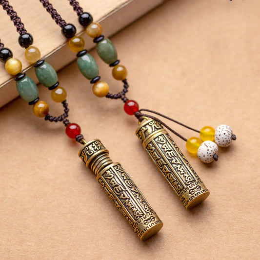 Pair of antique brass Tibetan prayer box necklaces with engraved Sanskrit script, green aventurine, tiger's eye, and bodhi seed tassels on braided cord