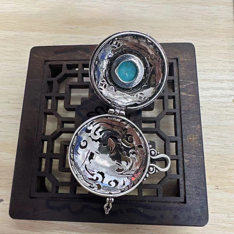 Tibetan Pi Xiu Necklace – Fully opened silver locket interior detail on wood base