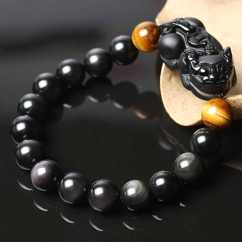 FengShui PiXiu Rainbow Obsidian Bracelet – black obsidian PiXiu with tiger eye beads, dark reflective background, wealth