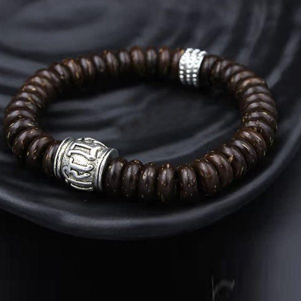 Om Mani Padme Hum Coconut Shell Bracelet – on dark ceramic dish, silver metal accents